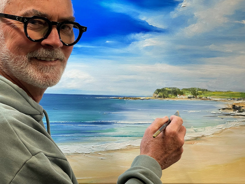 Geoff Barlow painting a coastal landscape in his studio