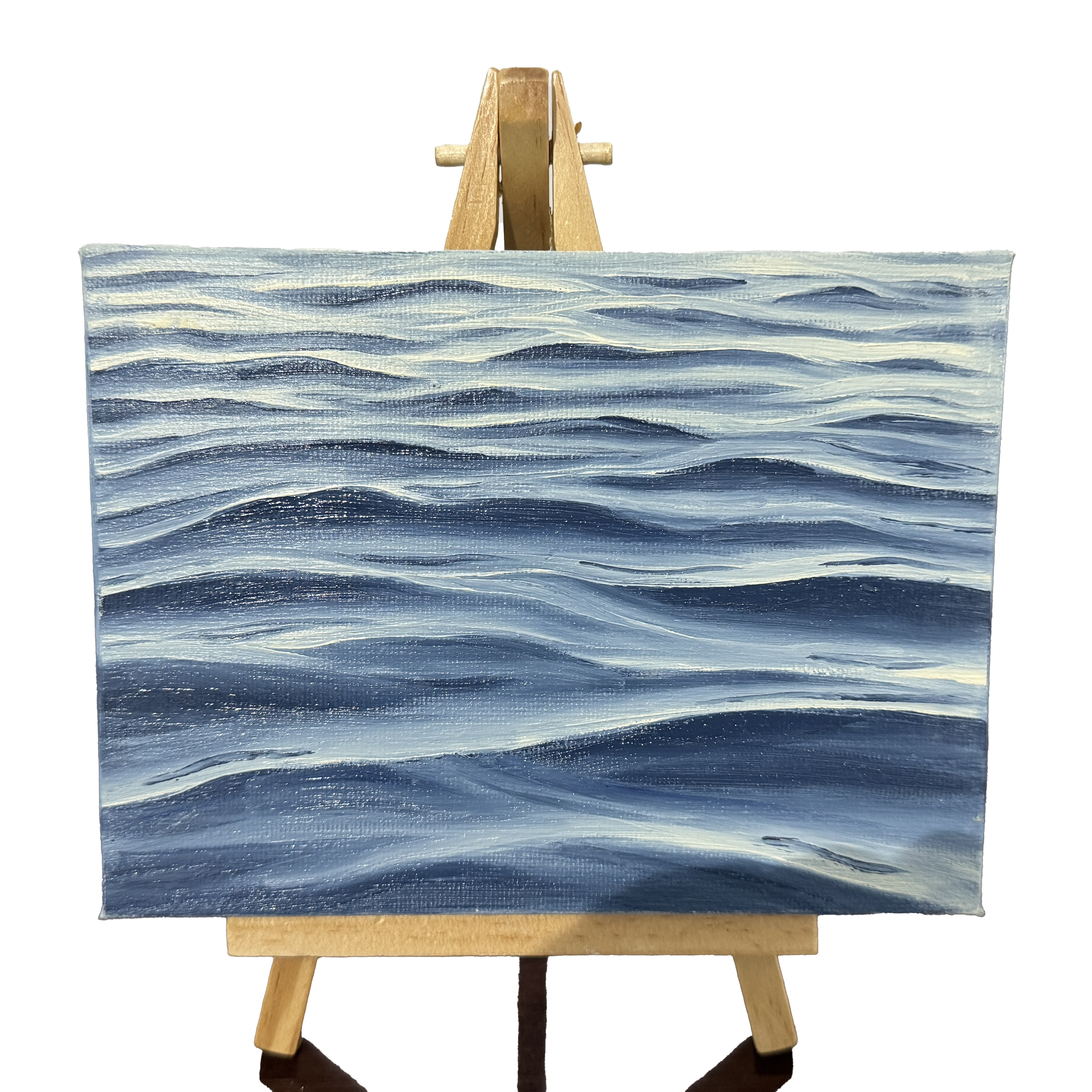 Oil painting on canvas of blue waves pattern on a wooden easel