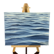 Oil painting on canvas of blue waves pattern on a wooden easel