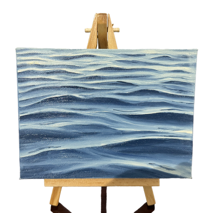 Oil painting on canvas of blue waves pattern on a wooden easel