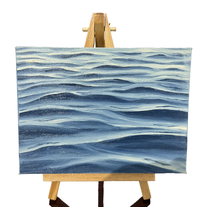 Oil painting on canvas of blue waves pattern on a wooden easel