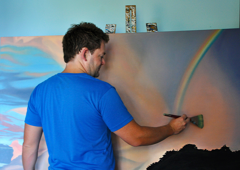 Mark Kingston painting a sky in his studio