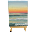 Oil painting of an ocean at sunset on a wooden stand