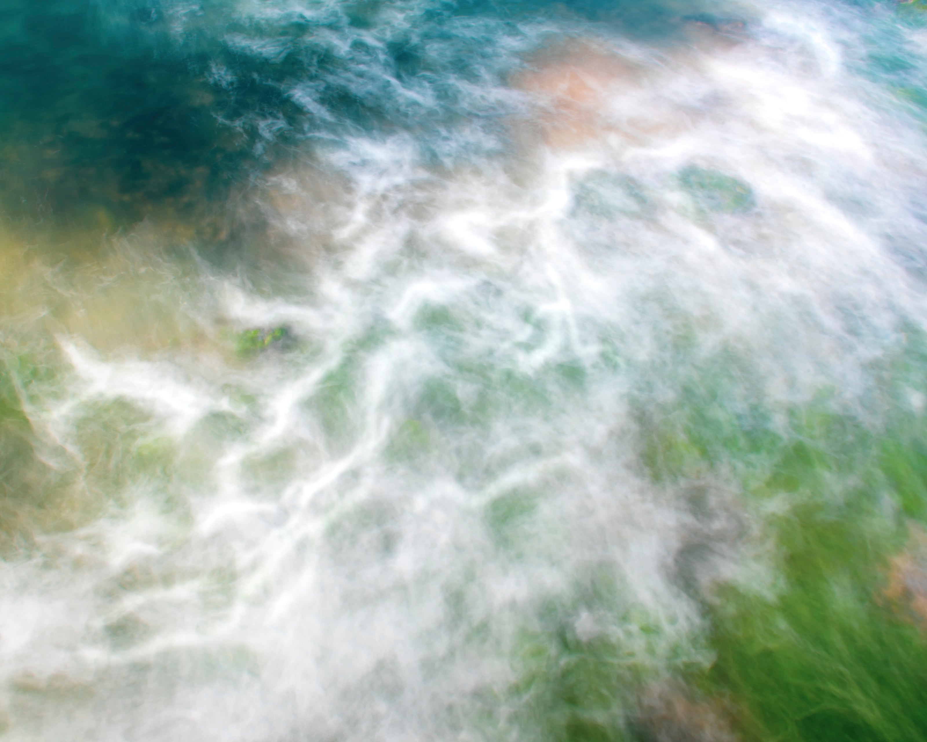 Abstract photo of turbulent ocean with white foam, green seaweed and turquoise water